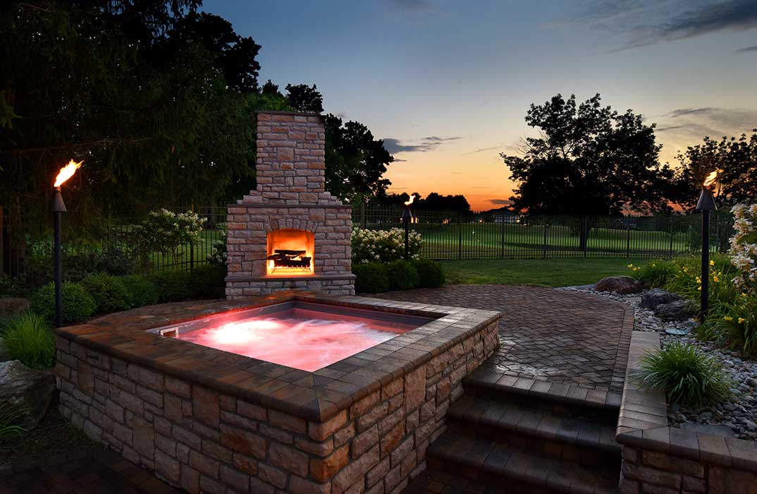 Tiki Torch with an Outdoor Fireplace and Hot Tub