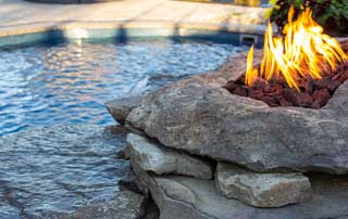 Fire feature on the side of a pool