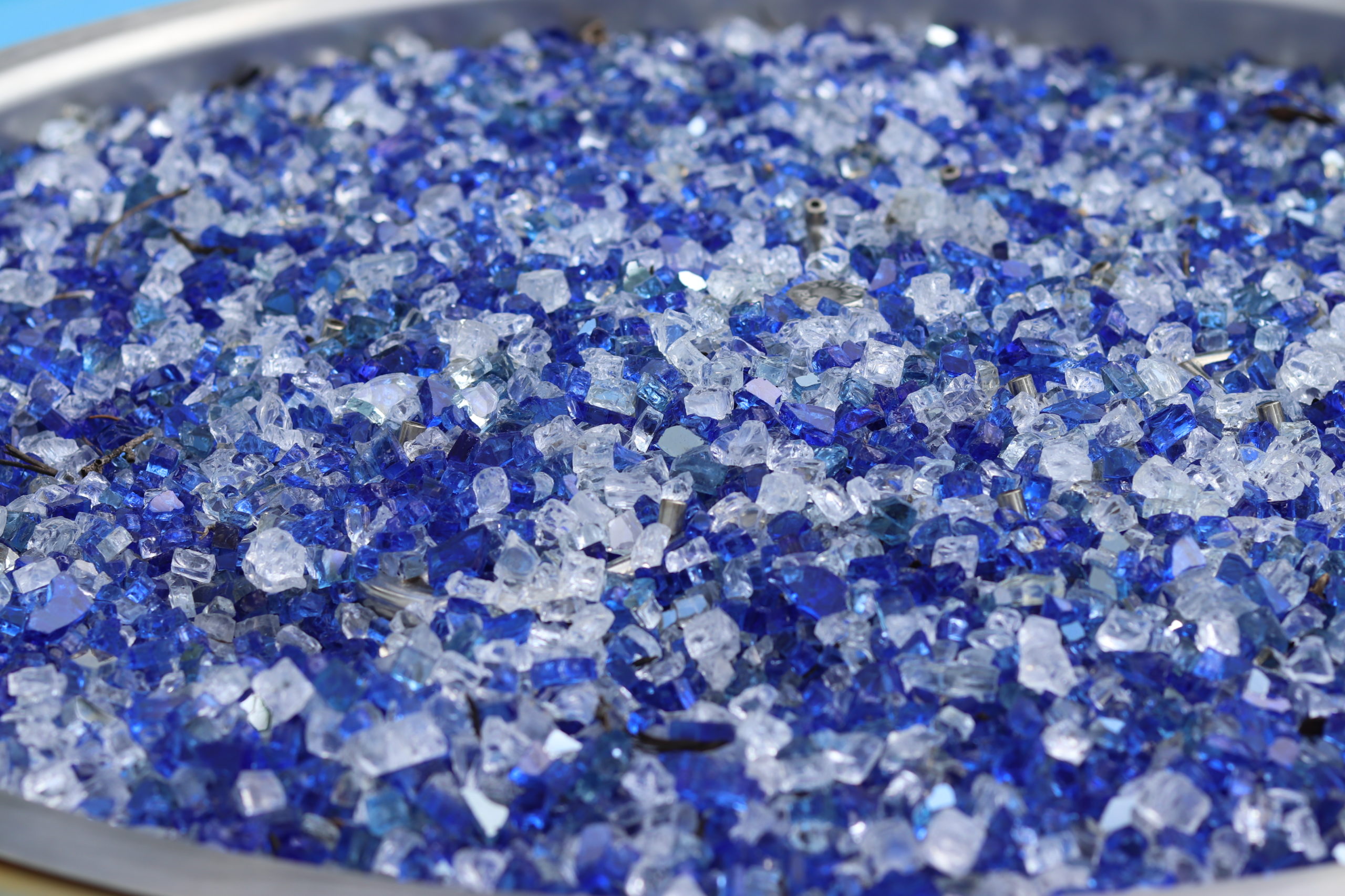 Blue and white fire glass in an aluminum bowl